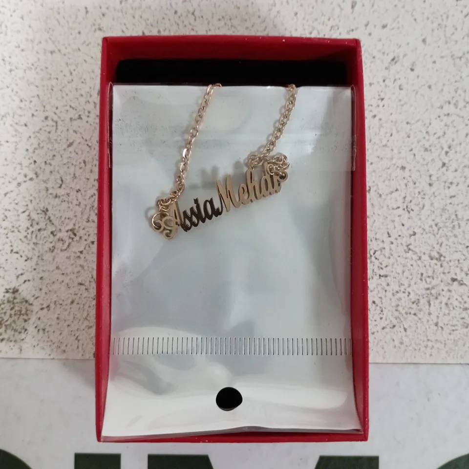 GOLD-TONE SCRIPT-NAME NECKLACE IN PINK GIFT BOX.