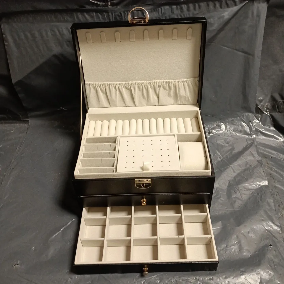 Black leather jewellery box with quilted lid and multi-compartment interiors