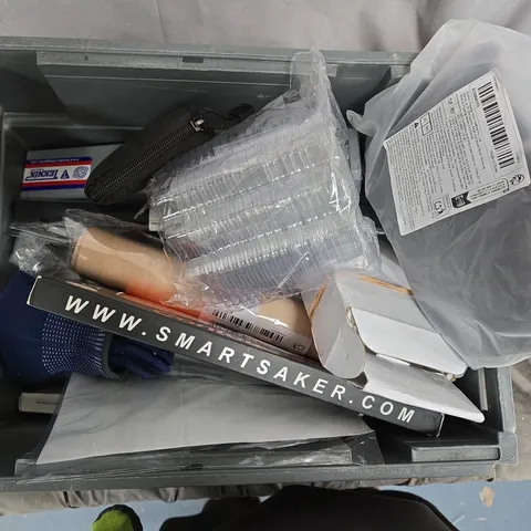 Assorted packaging materials and loose items in a crate – Smartsaker branding