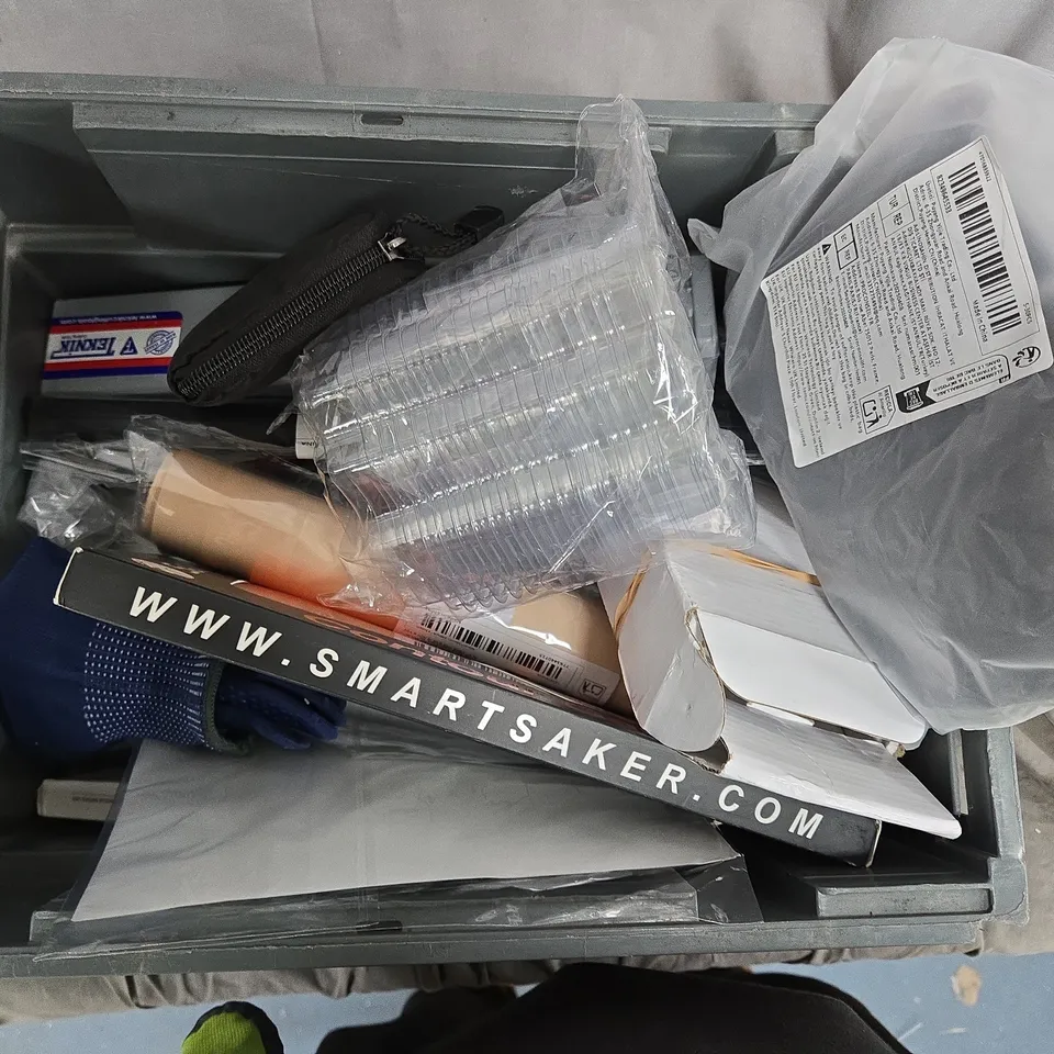 Assorted packaging materials and loose items in a crate – Smartsaker branding