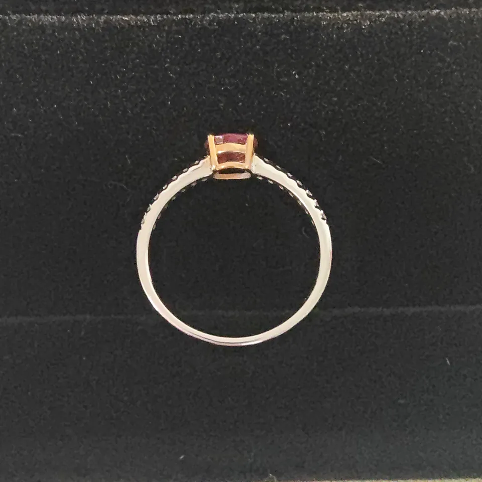 18CT GOLD RING SET WITH AN OVAL CUT RUBY AND DIAMONDS TO EACH SHOULDER WEIGHING +-0.66CT