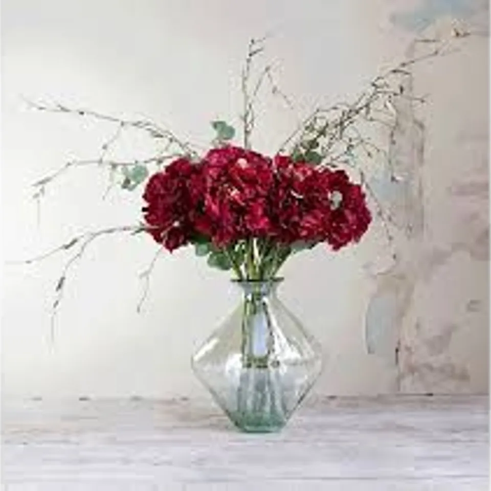 PEONY HYDRANGEAS AND FOILAGE IN AN AMBER FOOTED VASE