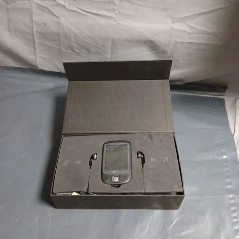 HTC SMARTPHONE IN BOXED PACKAGING – FOAM INSERTS AND HEADSET-LIKE ACCESSORIES 