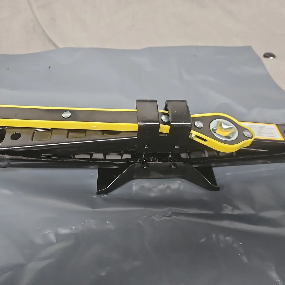 Scissor car jack with yellow operating handle 
