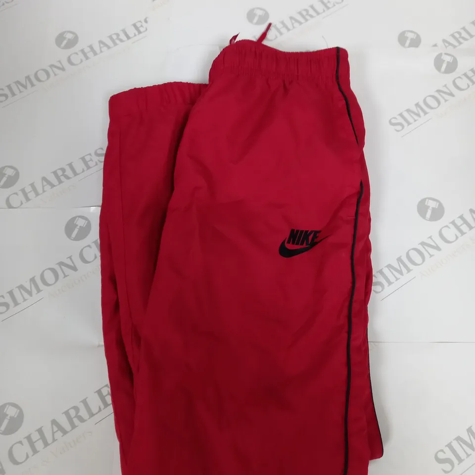 NIKE LOGO TRACKSUIT BOTTOMS IN RED SIZE 7