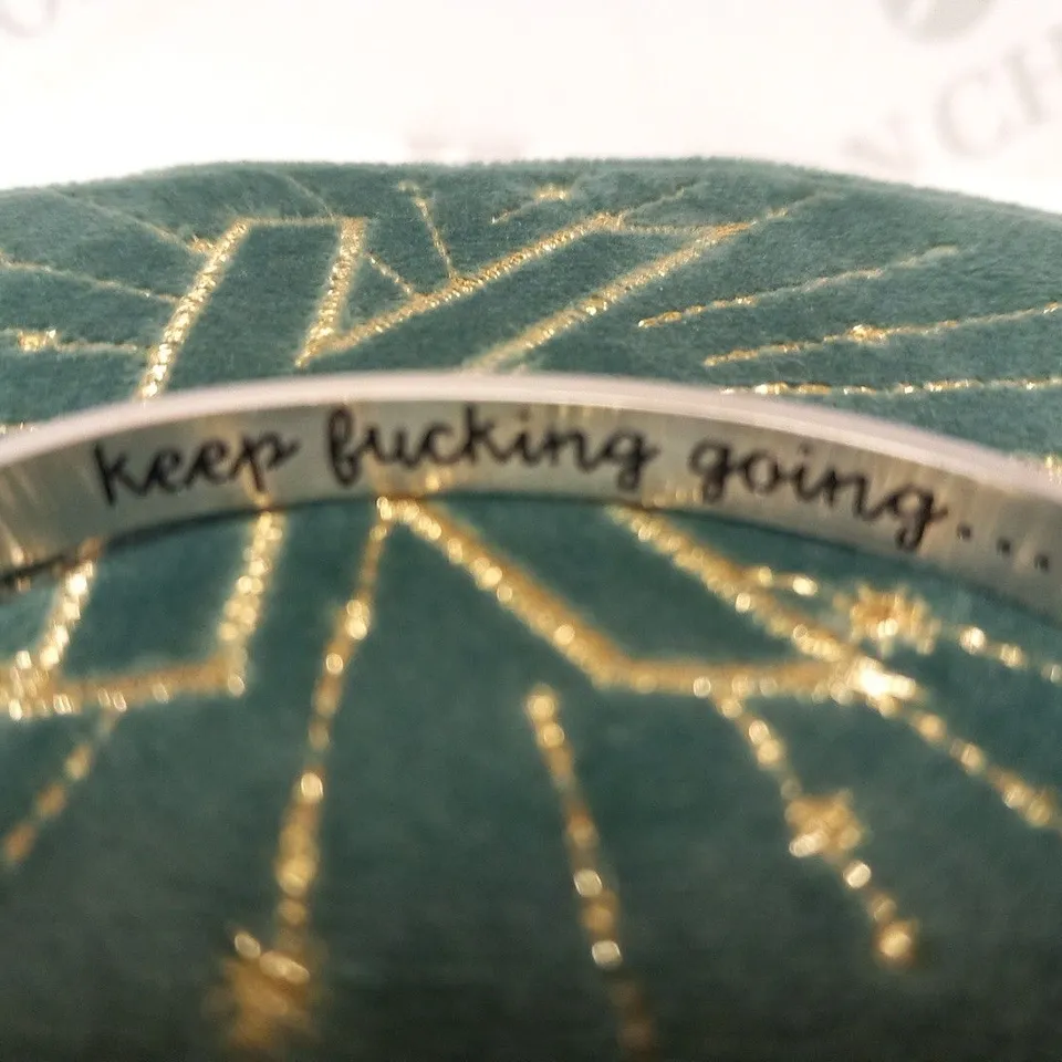 BRACELET INSCRIBED 'KEEP F***ING GOING'
