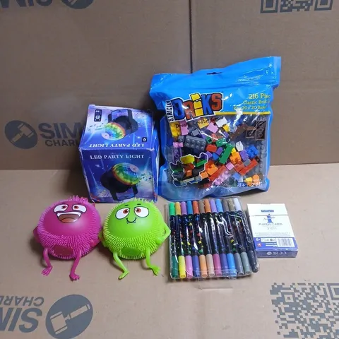 TOTE OF APPROXIMATELY 20 ASSORTED TOYS/RELATED ITEMS TO INCLUDE BRIKS, PLAYING CARDS, PENS, LED PARTY LIGHT, VARIOUS SQUEEZY PUFFER MONSTERS ETC