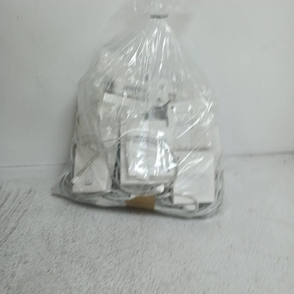a bag containing a large amount of apple products including earphones, wires, plugs etc.