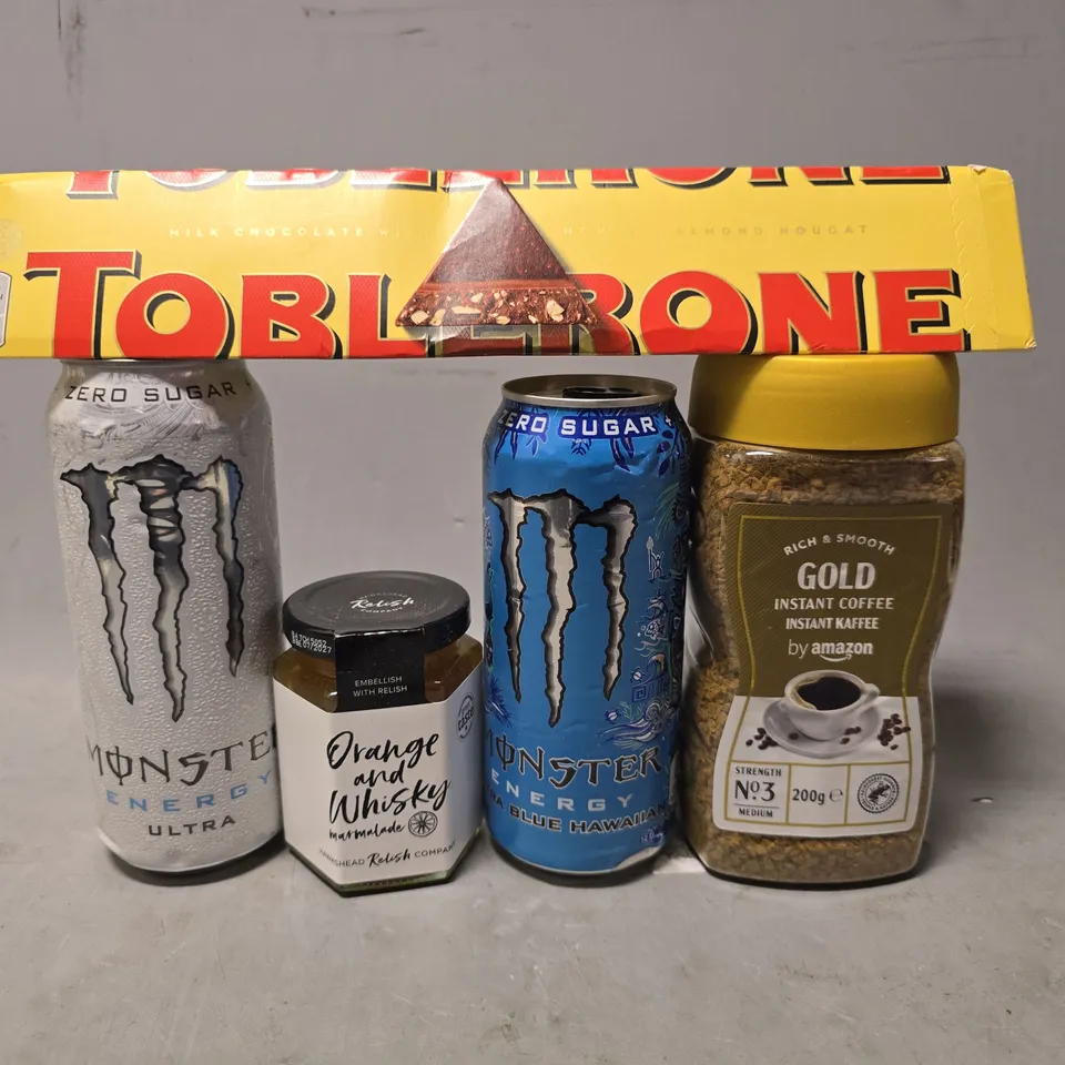 APPROXIMATELY 12 ASSORTED FOOD & DRINK ITEMS TO INCLUDE - TOBLERONE , MONSTER ULTRA , GOLD INSTANT COFFEE AMAZON ETC