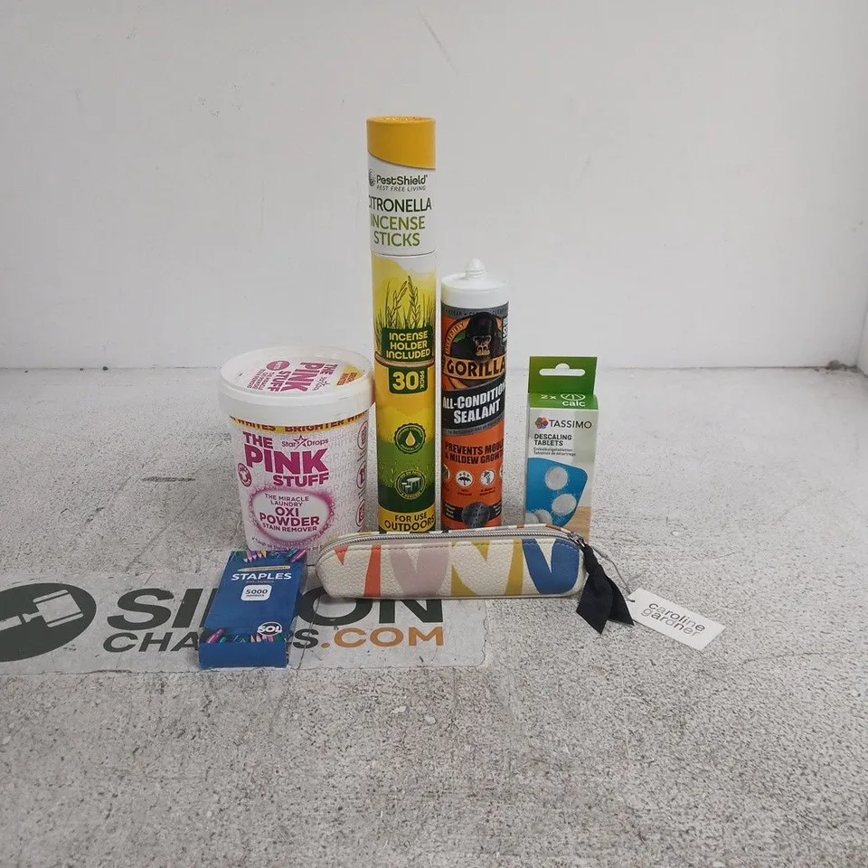 TOTE OF APPROXIMATELY 20 ASSORTED ITEMS TO INCLUDE TASSIMO DECALING TABLETS, PINK STUFF OXI POWDER, STAPLES, GORILLA ALL CONDITIONS SEALANT, CAROLINE GARDNER PENCIL CASE ETC