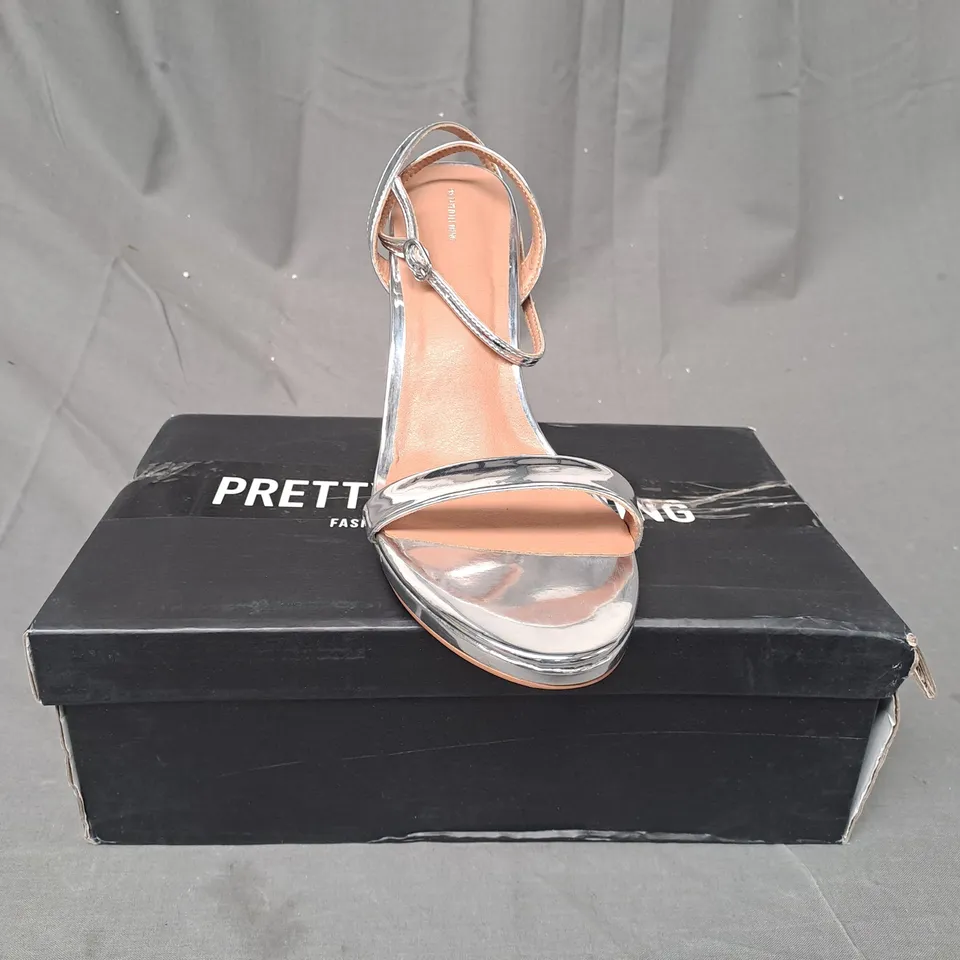 BOXED PAIR OF PRETTY LITTLE THING OPEN TOE HIGH HEEL SANDALS IN METALLIC SILVER UK SIZE 8