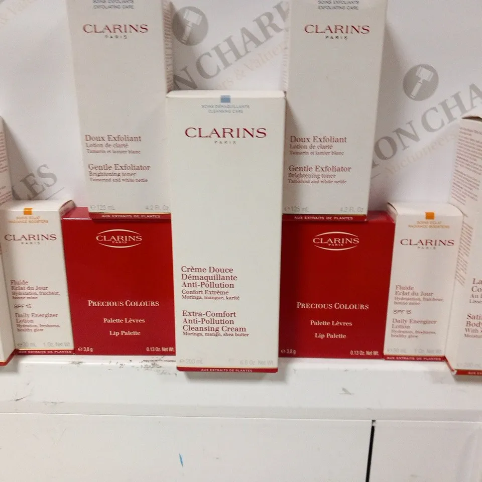 APPROXIMATELY 32 ASSORTED CLARINS PARIS COSMETICS PRODUCTS TO INCLUDE; SATIN SMOTH BODY LTION, DAILY ENERGIZER LTION, LIP PALETTE, GENTLE EXFLIATR, EXTRA COMFORT ANTI PLLUTION CLEASING CREAM 