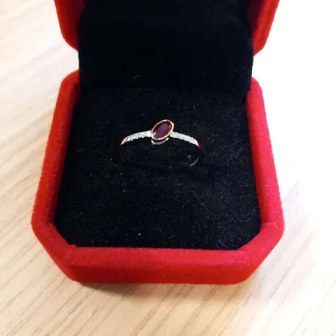 18CT GOLD RING RUB-OVER SET WITH AN OVAL CUT RUBY AND NATURAL DIAMONDS