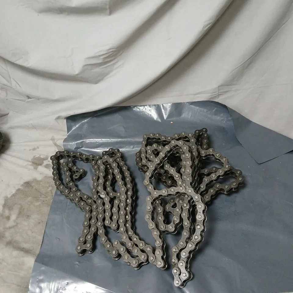  HEAVY-DUTY INDUSTRIAL OR MECHANICAL DRIVE CHAIN, LIKELY USED FOR VEHICLES LIKE GO-KARTS, MINI BIKES, ATVS. REPLACEMENT PART. 