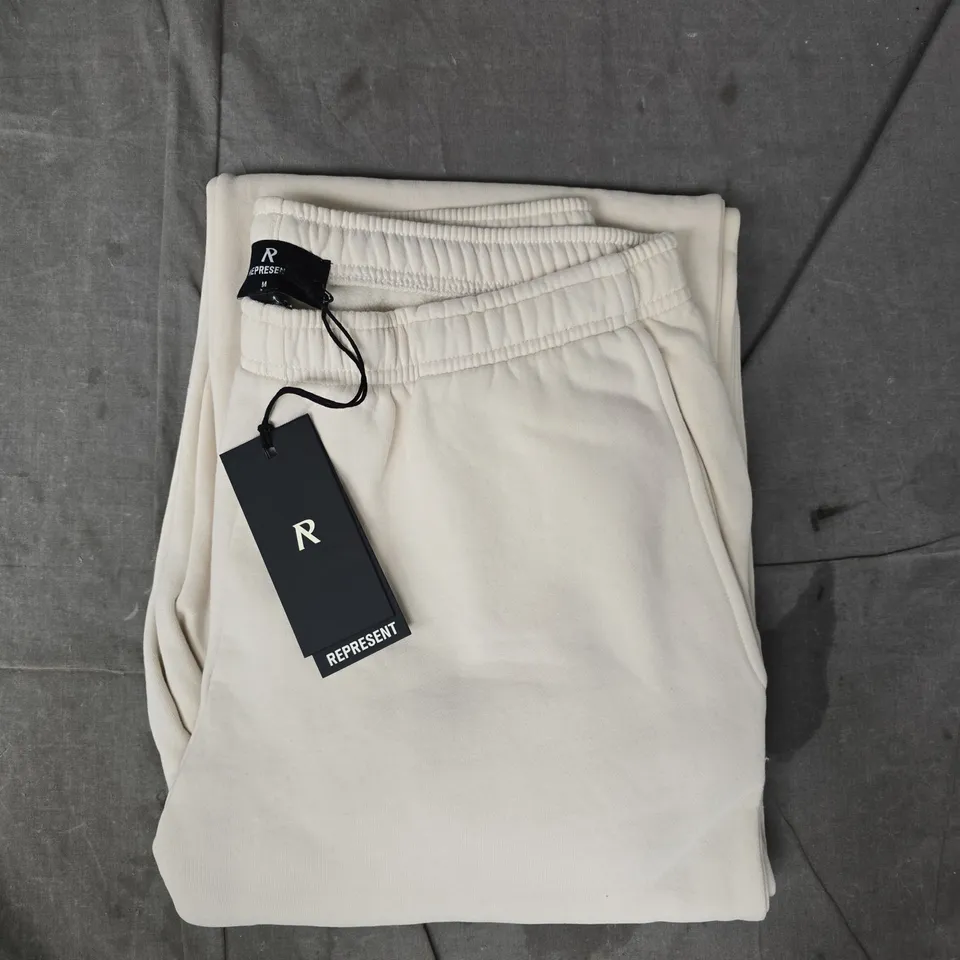 REPRESENT OWNER'S CLUB TRACK PANTS IN OAT MILK SIZE MEDIUM