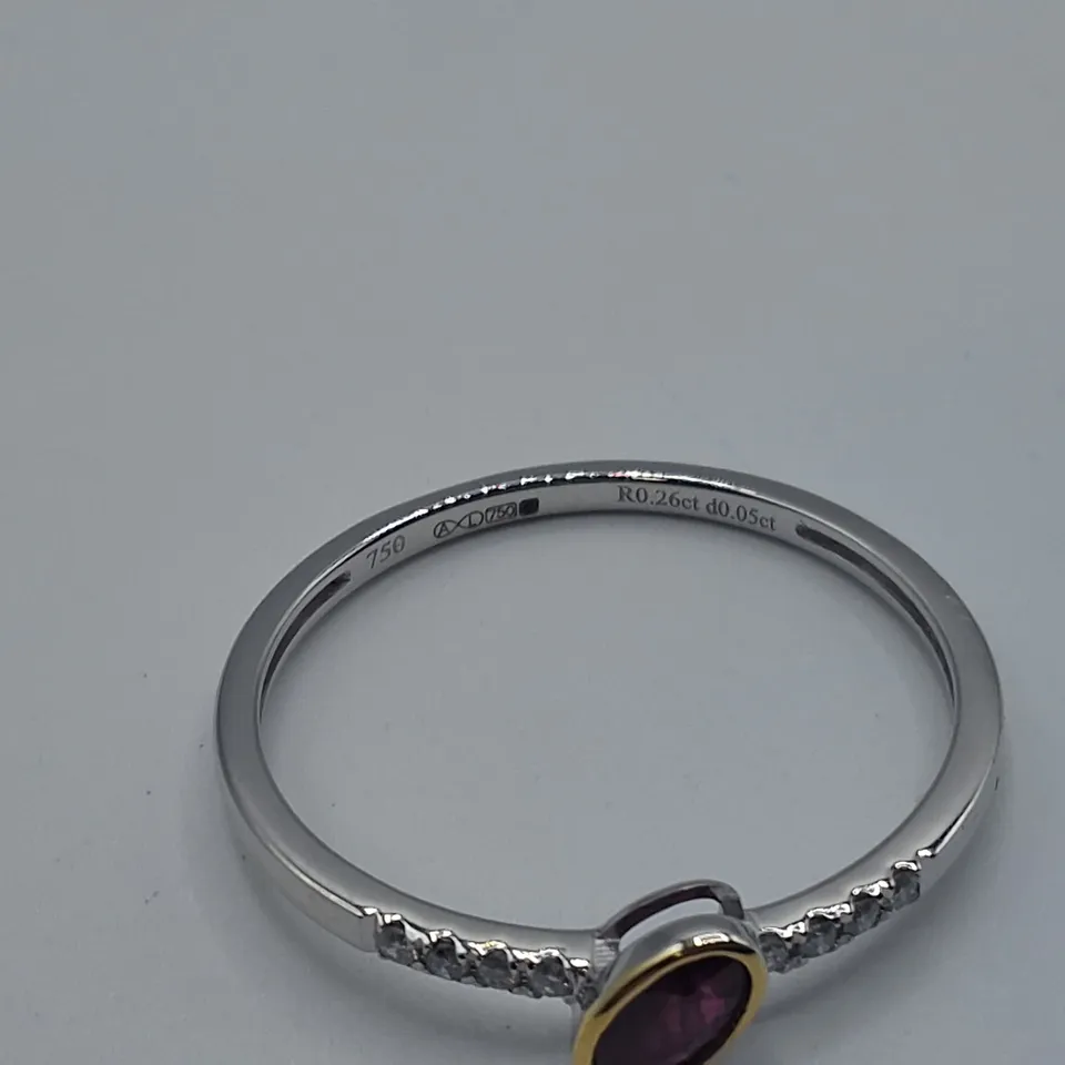 18CT GOLD RING WITH AN OFF-SET ROB OVER OVAL CUT RUBY AND NATURAL DIAMONDS TO EACH SHOULDER