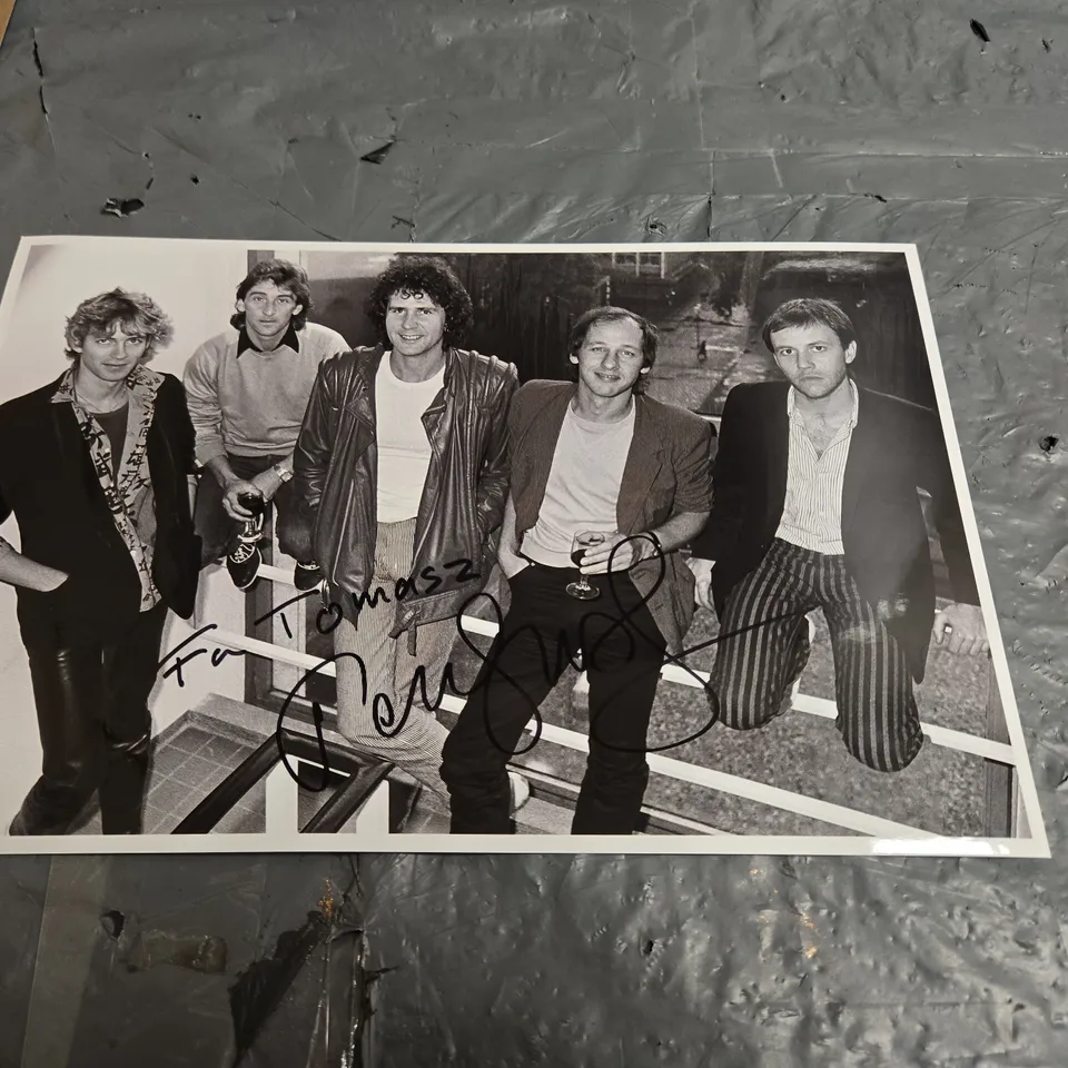 SET OF 4 AUTOGRAPHED ROCK PHOTOGRAPHS (SIGNED BY MARK KNOPFLER)