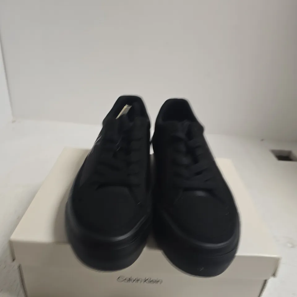 BOXED PAIR OF CALVIN KLEIN BLACK VULC FLAT LACE-UP SNEAKERS – UK5