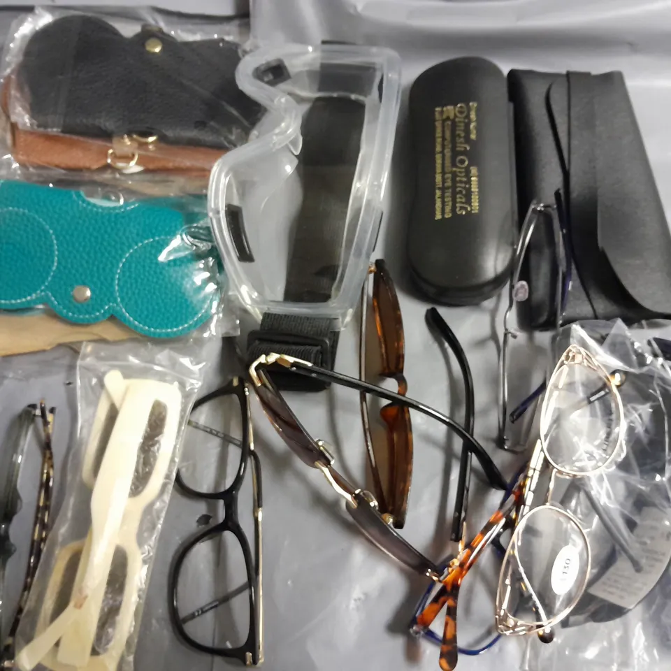 lot of assorted pairs of glasses and cases