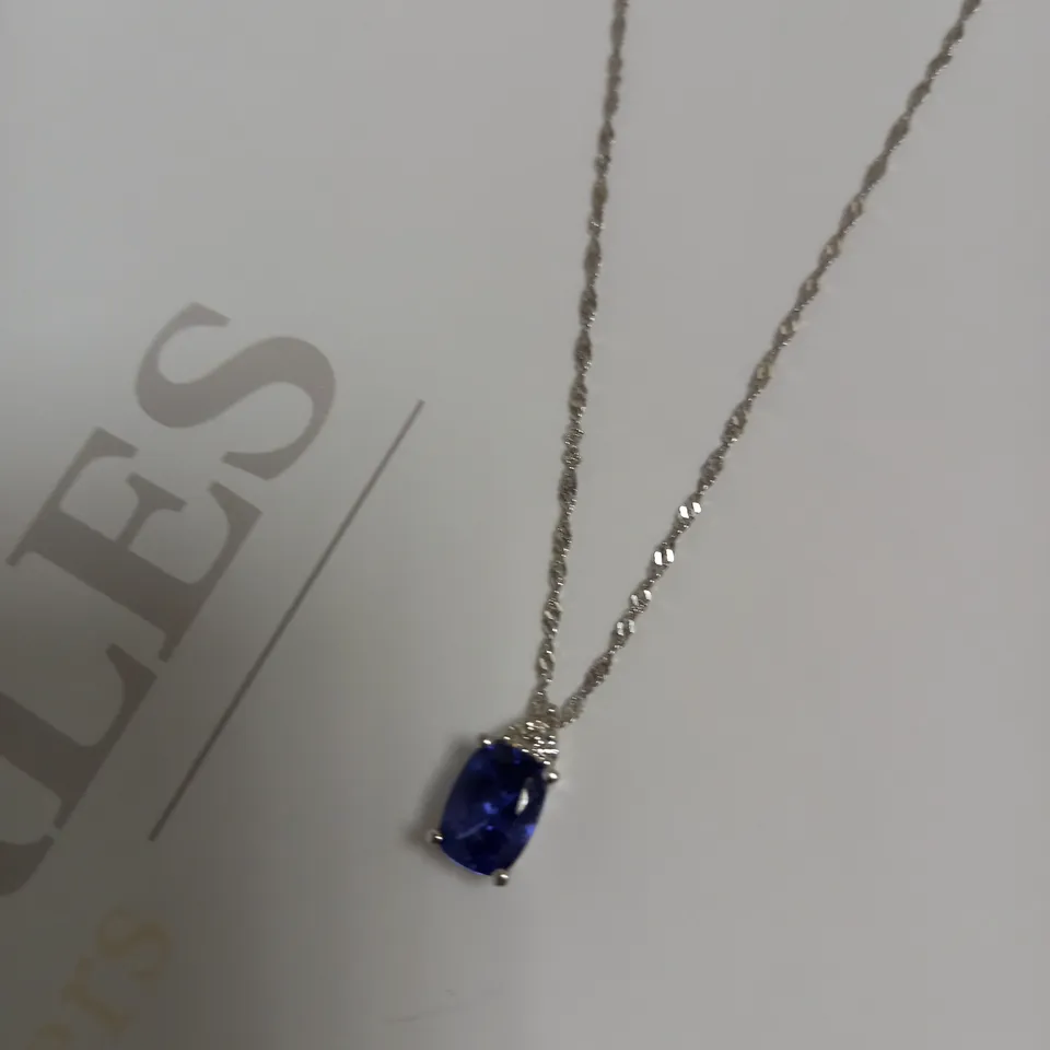 DESIGNER 18CT WHITE GOLD PENDANT ON A CHAIN, SET WITH AN OVAL CUT TANZANITE AND DIAMONDS WEIGHING +-1.44CT
