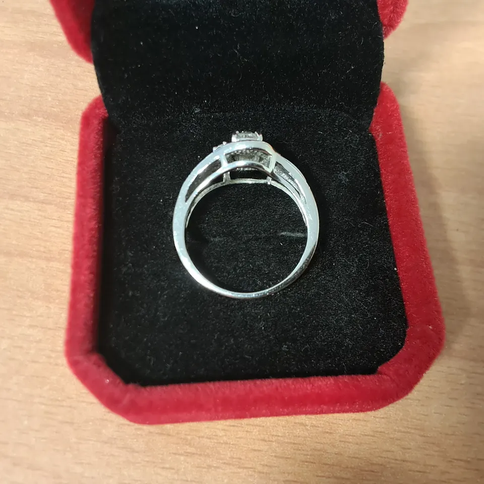 18CT WHITE GOLD RING SET WITH A NATURAL OVAL CUT DIAMOND TO NATURAL DIAMOND HALO