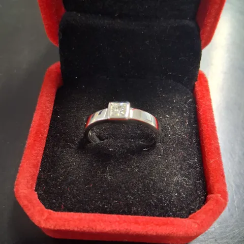 18CT WHITE GOLD SOLITAIRE RING RUB-OVER SET WITH A NATURAL PRINCESS CUT DIAMOND