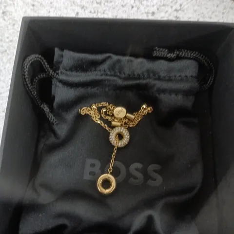 HUGO BOSS GOLD-TONE JEWELRY WITH CIRCULAR PENDANT – BOXED