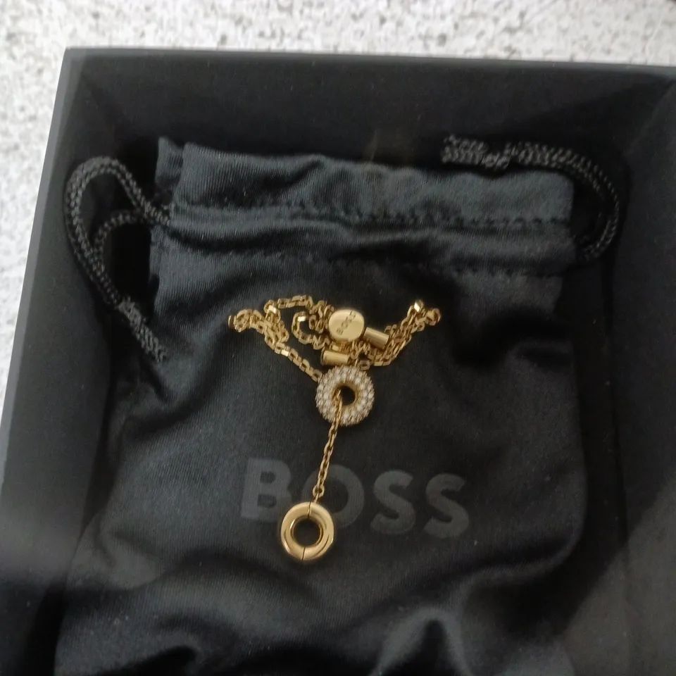 HUGO BOSS GOLD-TONE JEWELRY WITH CIRCULAR PENDANT – BOXED