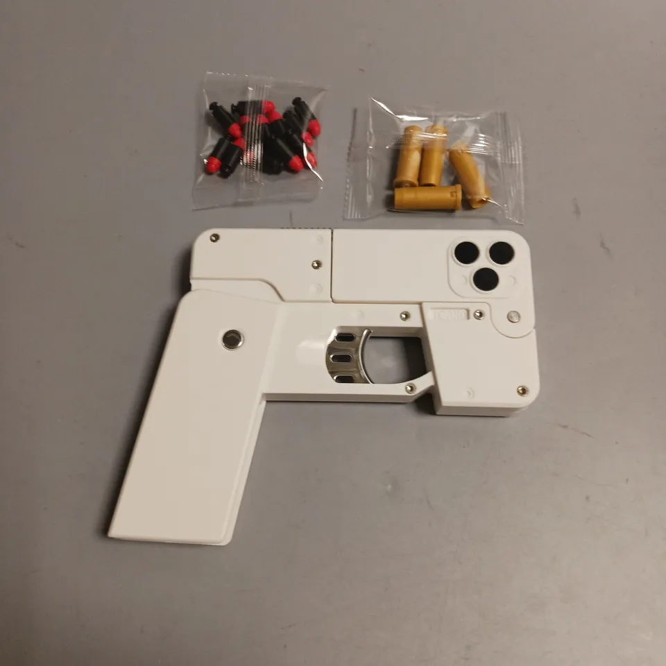 FOLD MOBILE PHONE SOFT BULLET LAUNCHER IN WHITE INCLUES BULLETS AND CARTRIDGE CASES