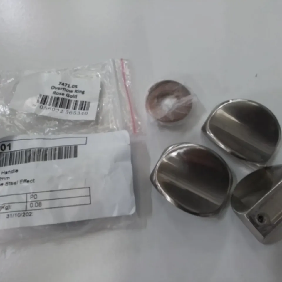 LOT OF ASSORTED FITTING ITEMS INCLUDES OLINDA STAINLESS STEEL EFFECT HANDLES AND OVERFLOW RINGS IN ROSE GOLD