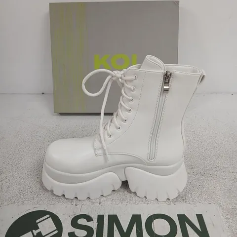 BOXED KOI RANCOR LACE UP MONSTER PLATFORM BOOTS IN WHITE, UK6