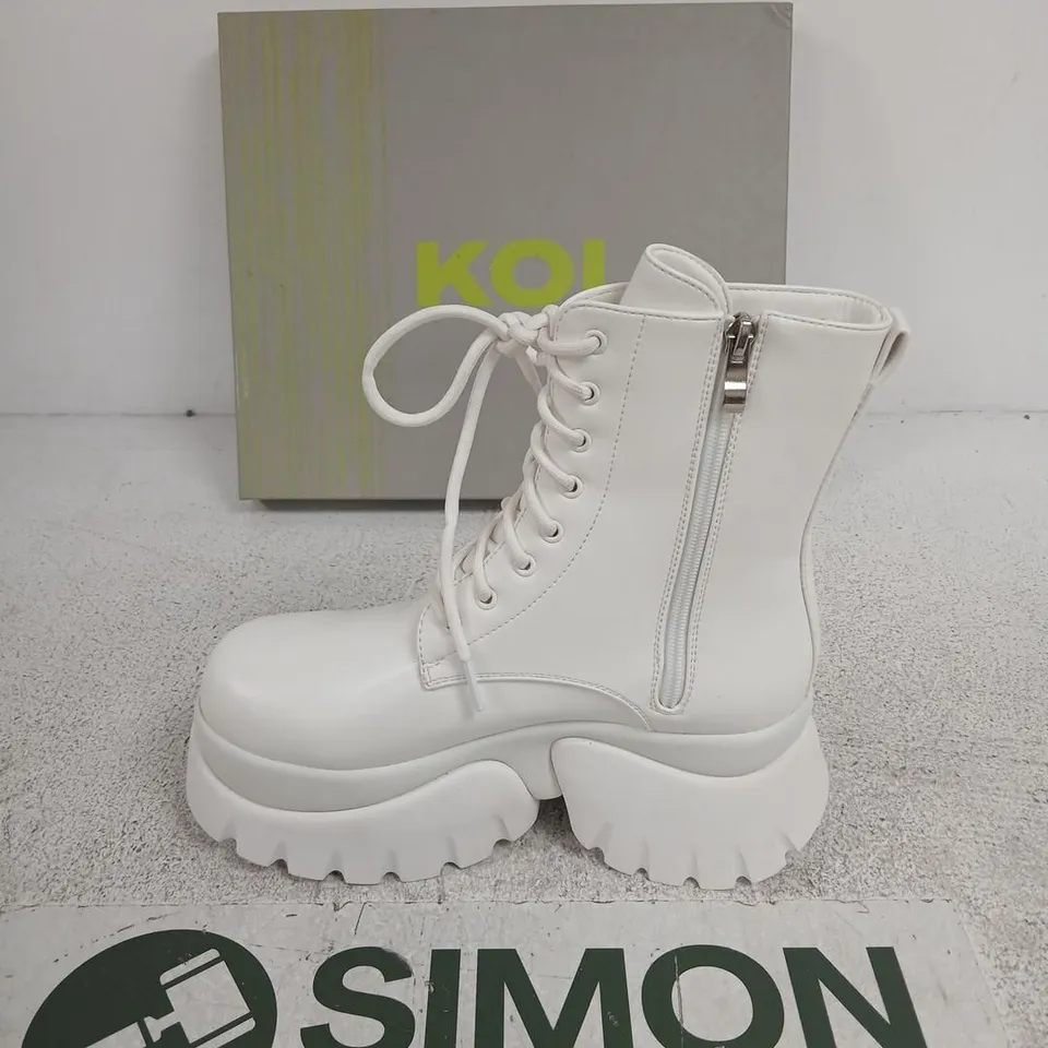 BOXED KOI RANCOR LACE UP MONSTER PLATFORM BOOTS IN WHITE, UK6
