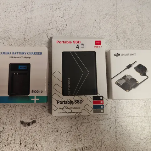 APPROXIMATELY 10 ASSORTED HOUSEHOLD ITEMS TO INCLUDE CAMERA BATTERY CHARGER, PORTABLE SSD, ETC