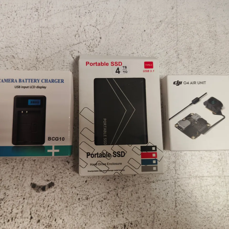 APPROXIMATELY 10 ASSORTED HOUSEHOLD ITEMS TO INCLUDE CAMERA BATTERY CHARGER, PORTABLE SSD, ETC