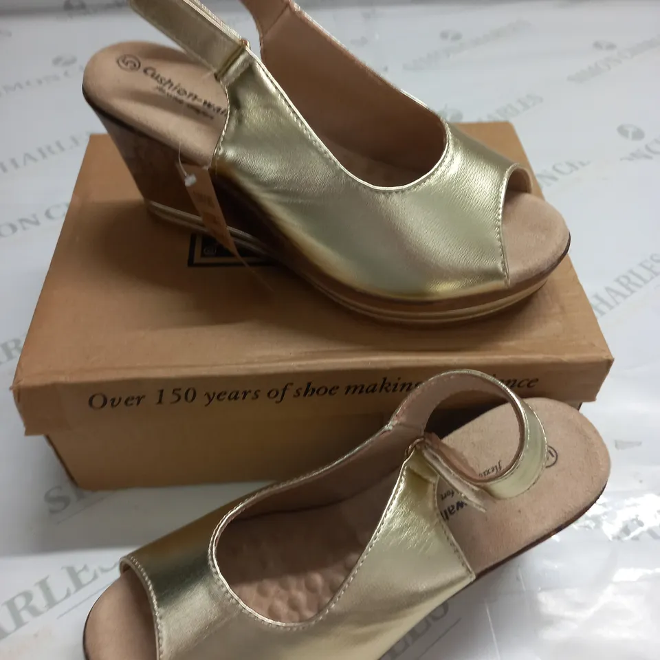 BOXED PAIR OF CUSHION WALK GOLD WEDGE HEEL SHOES IN GOLD - SIZE 5
