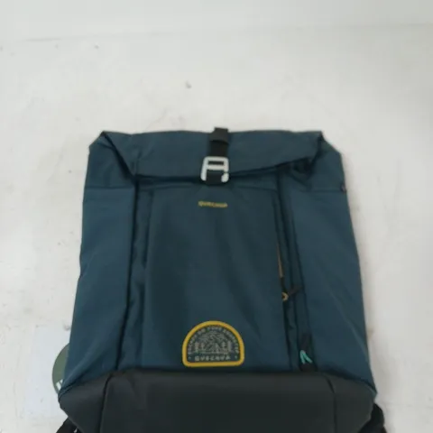 BLUE BACKPACK WITH YELLOW CIRCULAR LOGO PATCH AND BUCKLE-FLAP CLOSURE