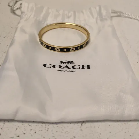 COACH GOLD-TONE BRACELET WITH BLACK ENAMEL AND CRYSTAL ACCENTS