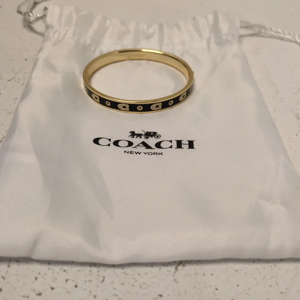 COACH GOLD-TONE BRACELET WITH BLACK ENAMEL AND CRYSTAL ACCENTS
