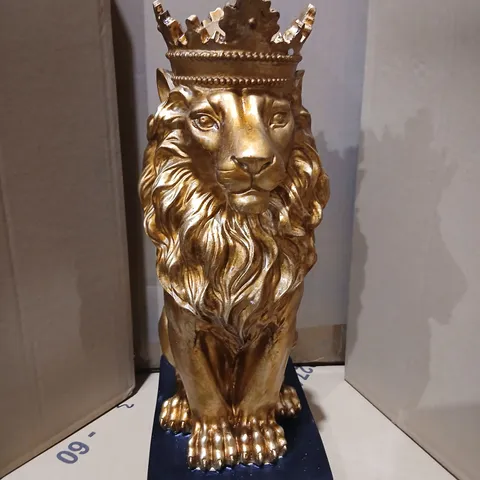 TWO GISELA GRAHAN GOLD-TONE LION ORNAMENT WITH CROWN ON DARK BASE