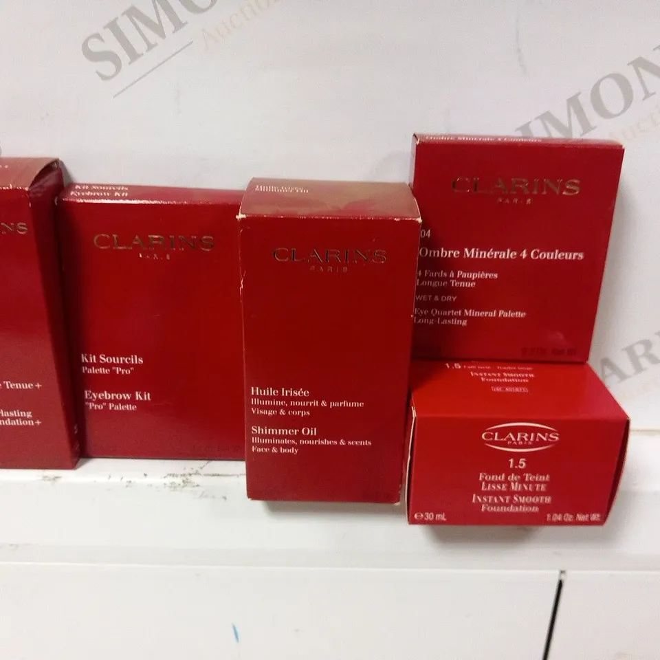 APPROXIMATELY 50 ASSORTED CLARINS PARIS COSMETICS PRODUCTS TO INCLUDE; SHIMMER OIL, EYEBROW KIT, EVERLASTING FOUNDATION, INSTANT SMOOTH FOUNDATION AND EYE QUARTET MINERAL PALETTE LONG LASTING