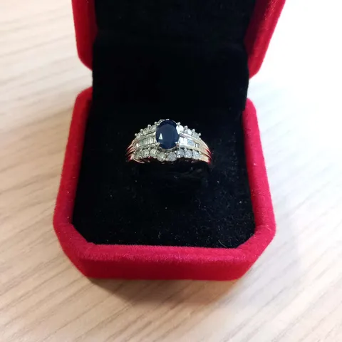 9CT WHITE GOLD DRESS RING SET WITH AN OVAL SAPPHIRE AND NATURAL DIAMONDS WEIGHING +1.30CT