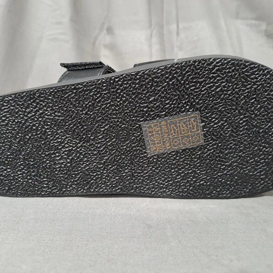 BOXED PAIR OF DESIGNER OPEN TOE FLAT SANDALS IN BLACK EU SIZE 36