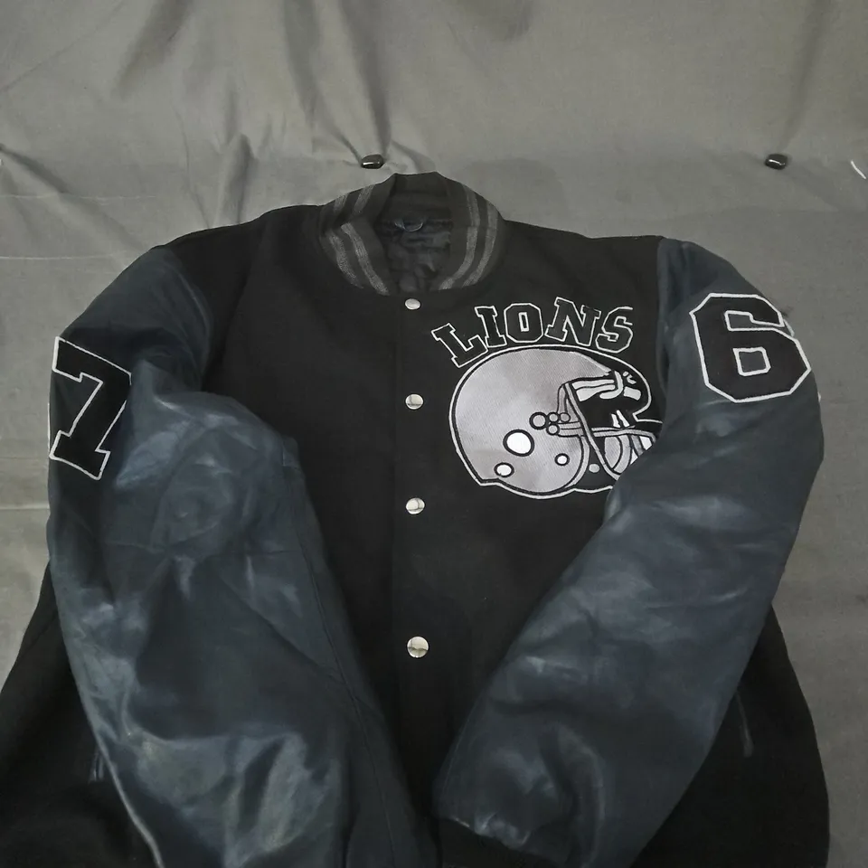VARSITY JACKET – BLACK BODY WITH GREY SLEEVES, 'LIONS' HELMET LOGO - SIZE UNSPECIFIED 