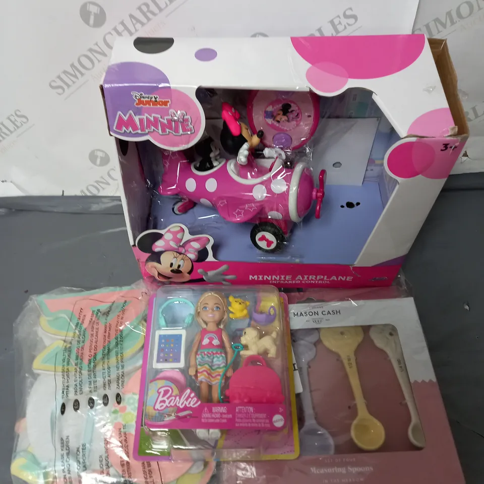 A SELECTION OF GOODS TO INCLUDE A TRAVEL BARBIE AND DOG, A MINNIE MOUSE AIRPLANE AND A SET OF MEASURING SPOONS.