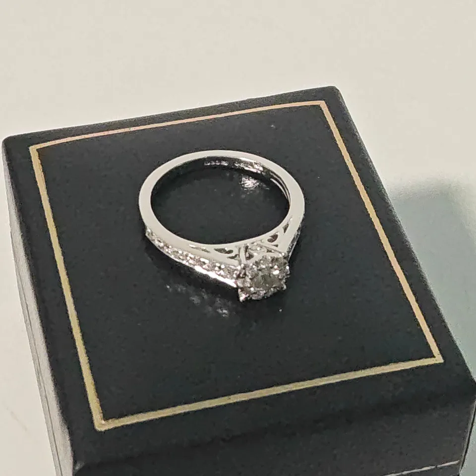 18CT WHITE GOLD RING SET WITH A NATURAL DIAMONDS AND WITH NATURAL DIAMOND SHOULDERS