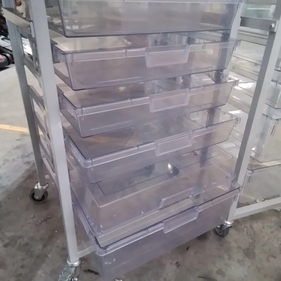 TWO METAL FRAMED TROLLEYS WITH 5 CLEAR PLASTIC GRADUATED TRAYS