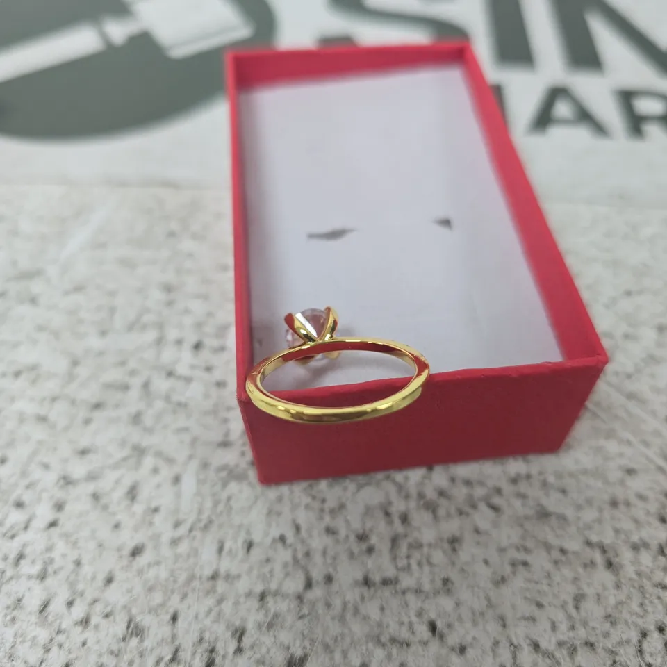 GOLD-TONE RING WITH CLEAR GEMSTONE IN RED PRESENTATION BOX