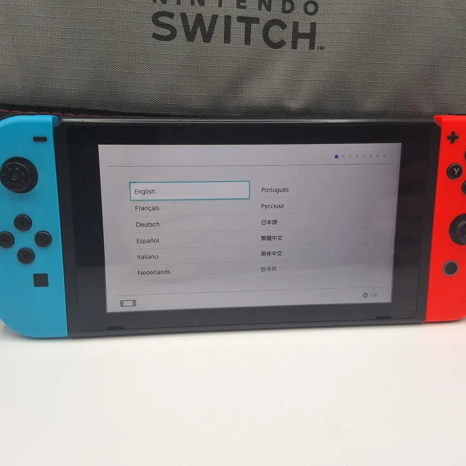 NINTENDO SWITCH HANDHELD CONSOLE WITH NINTENDO BRANDED MESSENGER CARRY BAG AND ACCESSORIES 