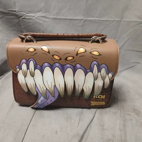 KOI DUNGEONS & DRAGONS THEMED HANDBAG WITH LARGE TOOTHY MOUTH GRAPHIC