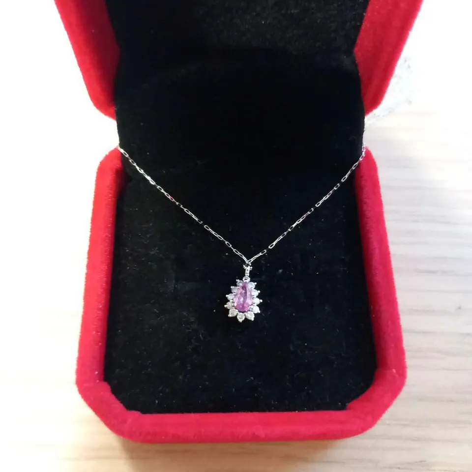 PLATINUM PENDANT ON A CHAIN SET WITH A PEAR SHAPED PINK SAPPHIRE TO NATURAL DIAMOND HALO